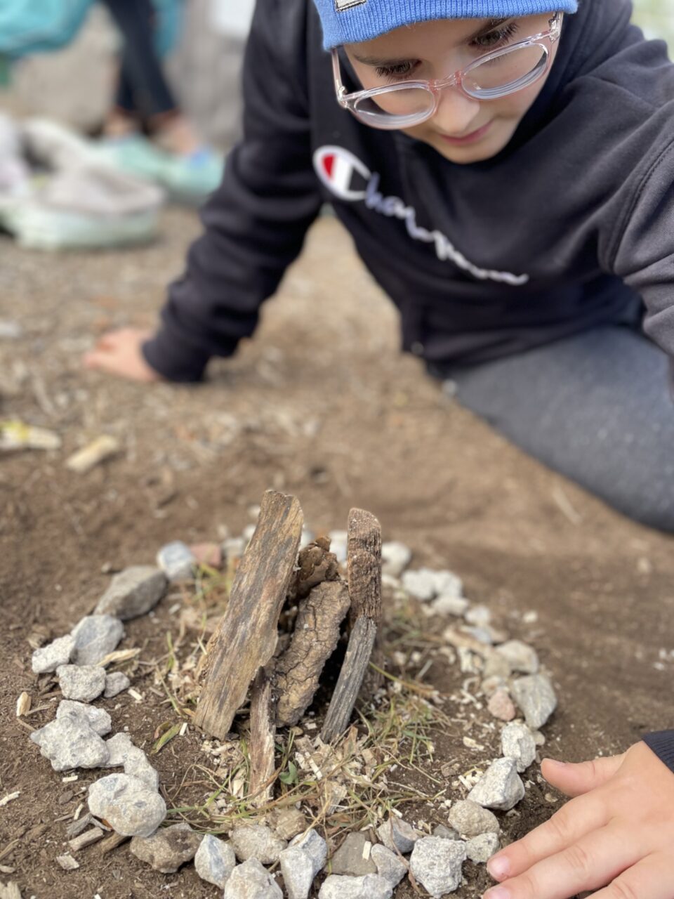Young Boy Building Small Camp Fire